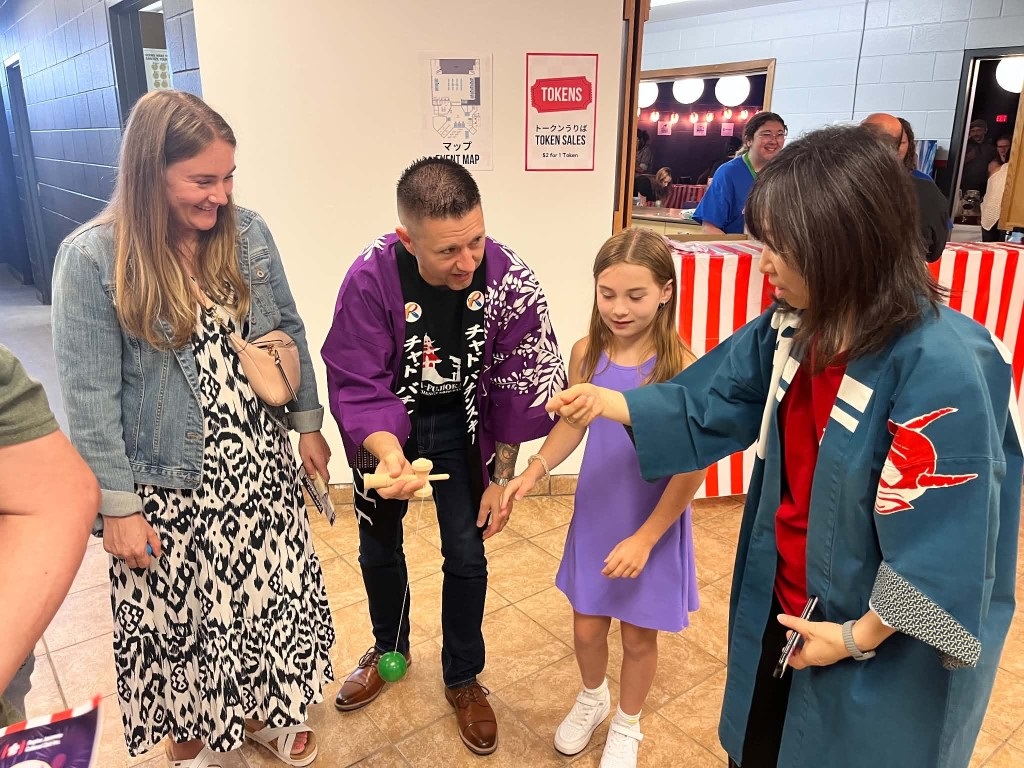 Mayor Bachynski and family learning how to play with a kendama