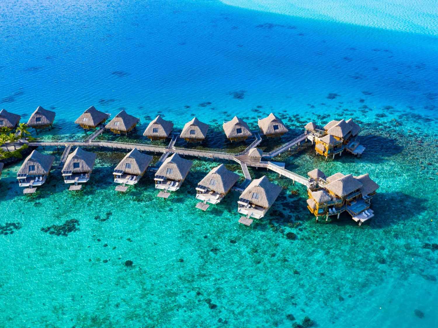An aerial photo of overwater bungalows in Moorea Island and Tahiti