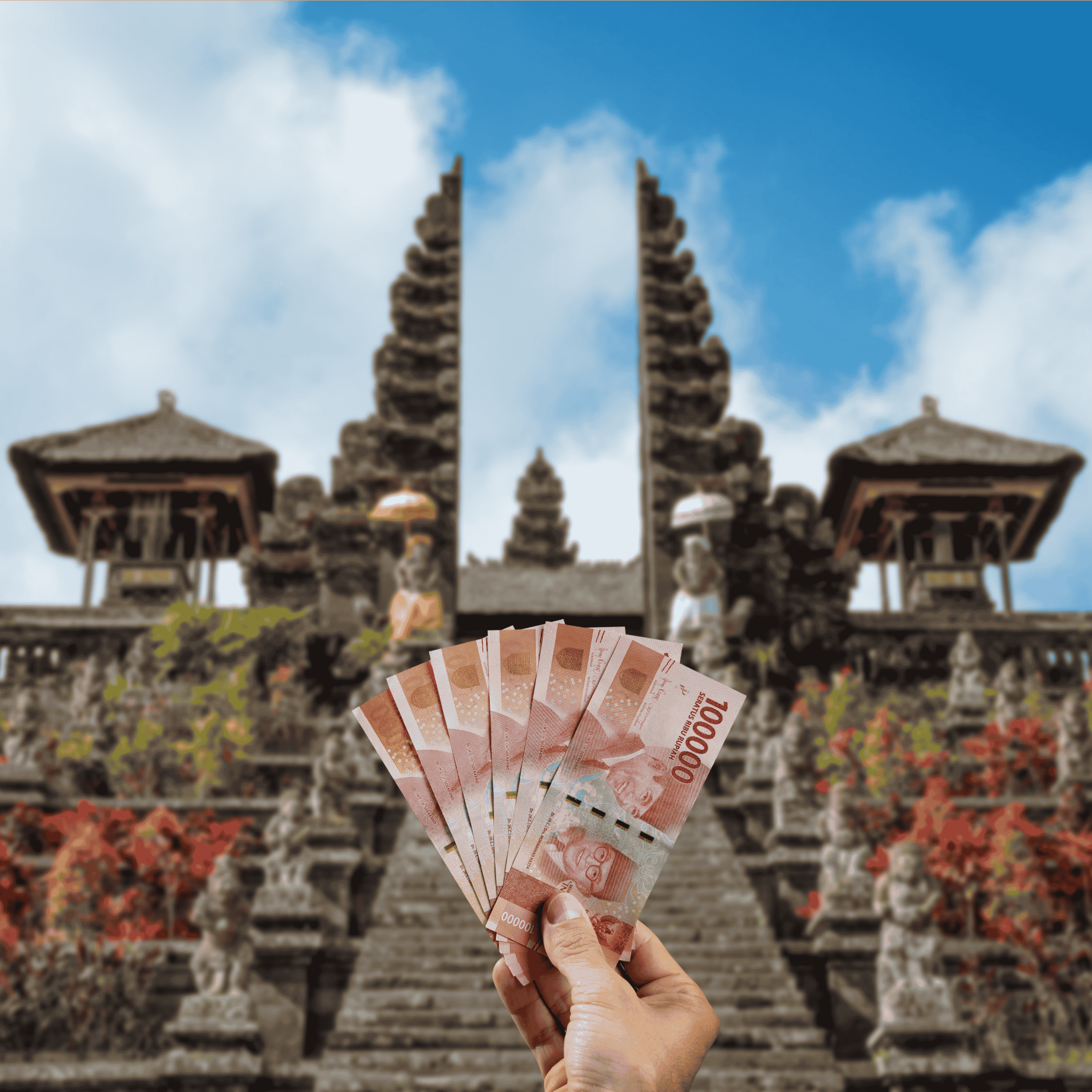 Traveller holding Indonesian Rupiah (IDR) currency in front of Besakih Temple in Bali, Indonesia