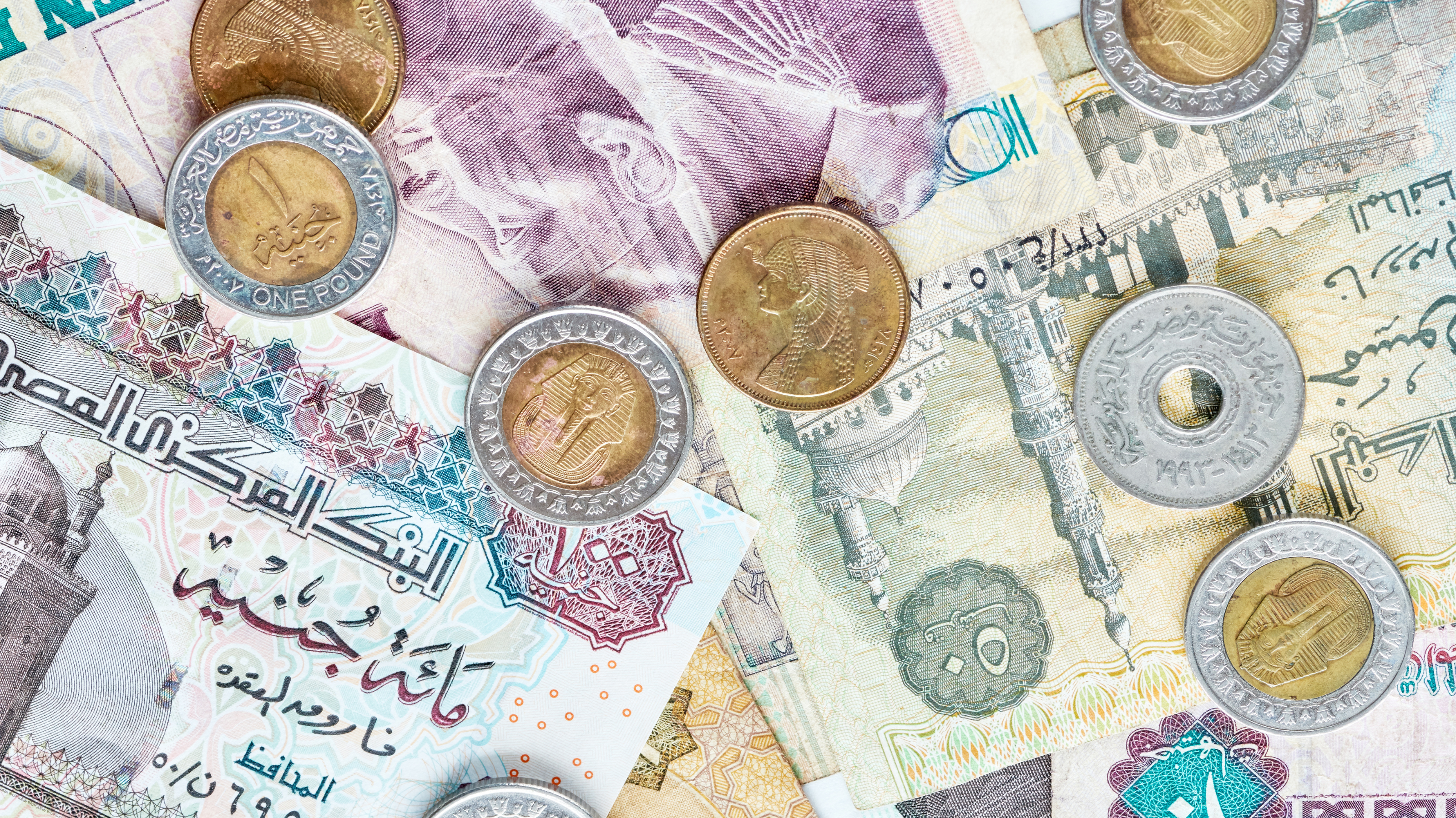 Egyptian currency banknote and coins