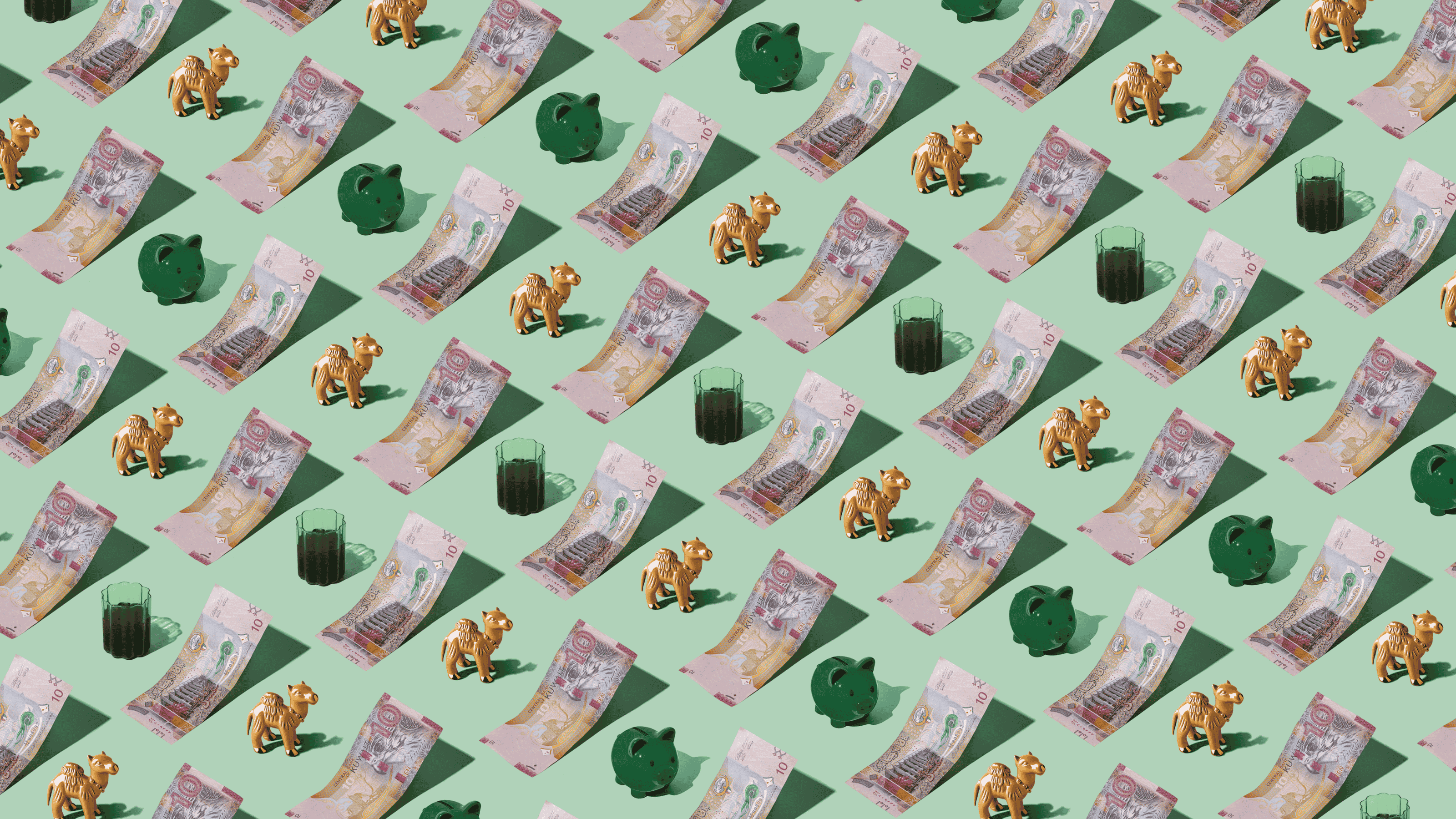 Kuwaiti Dinars (KWD) currency banknotes laid out in a repeating playful pattern with a green piggybank, tea, and camel figurine for Travel Money Oz.