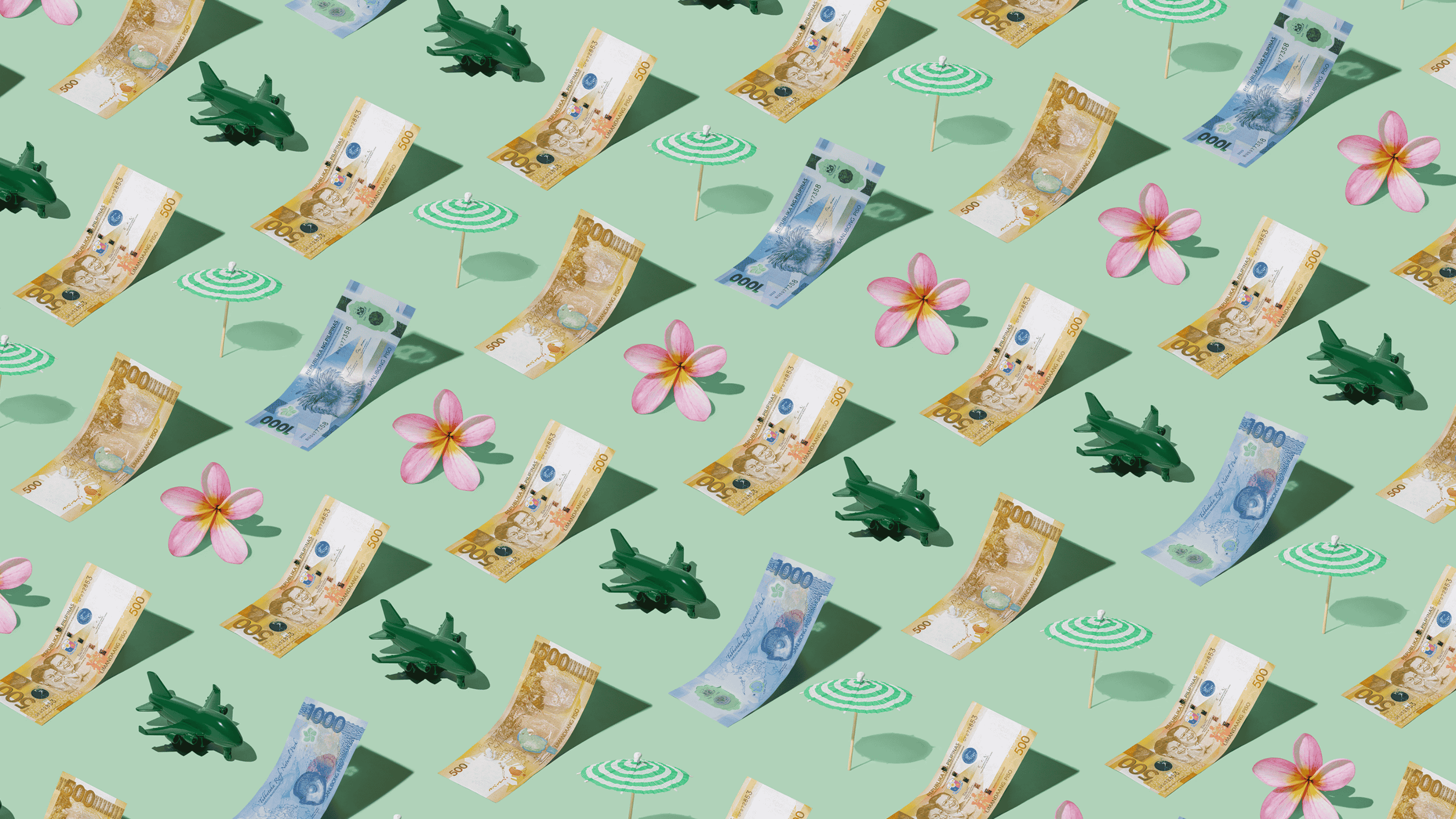 Philippine Pesos (PHP) currency banknotes laid out in a playful pattern with a green plane, green umbrella, and frangipani flower for Travel Money Oz.