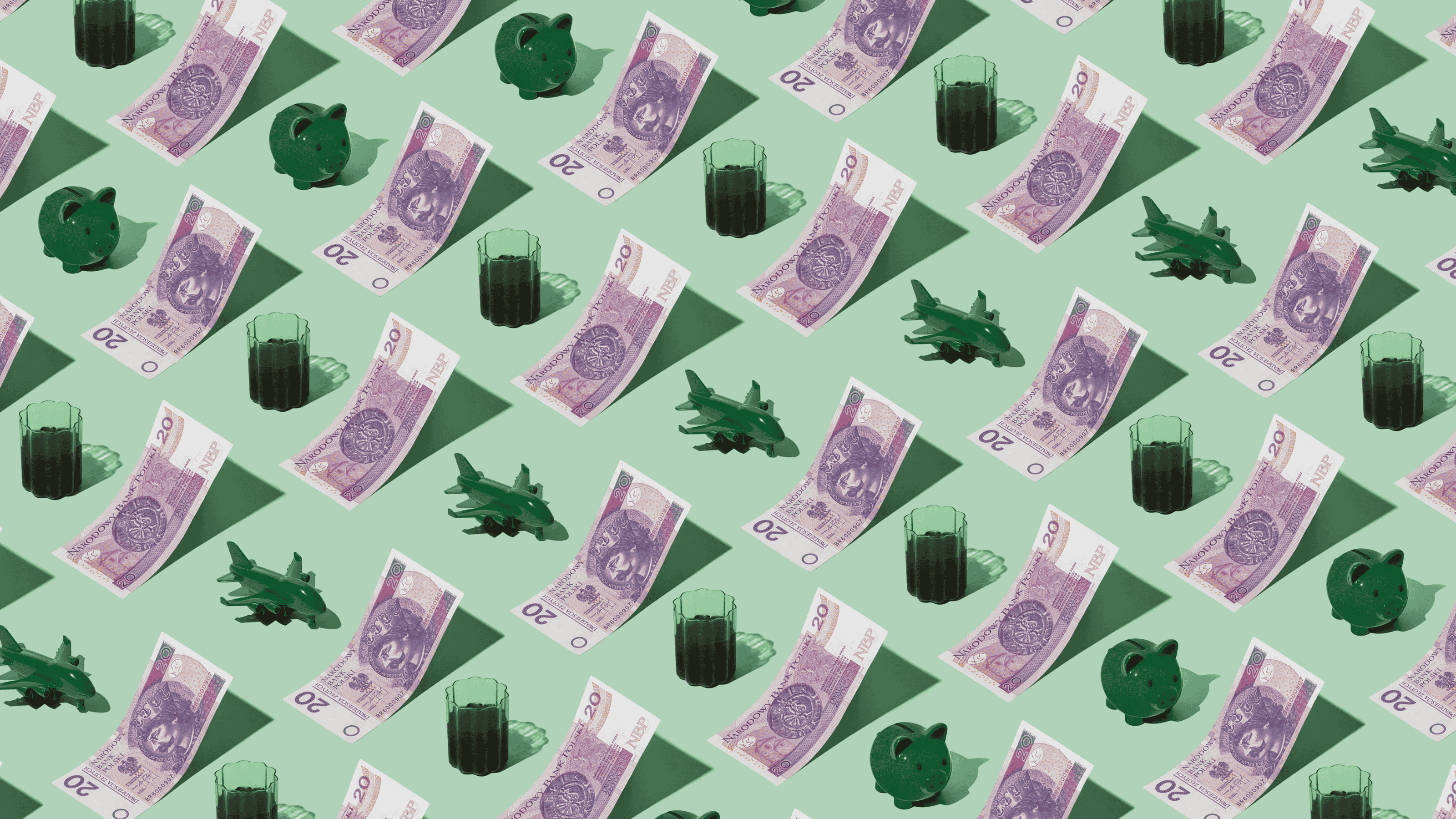 Polish Zloty (PLN) currency banknotes laid out in a playful pattern with a green plane, green piggybank, and tea for Travel Money Oz.