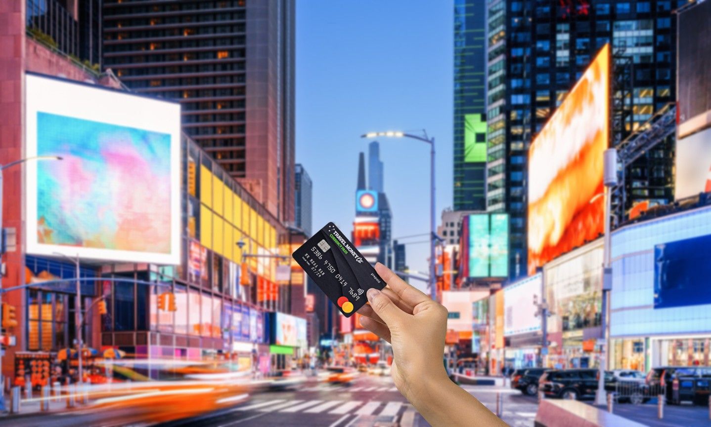 Using Currency Pass travel money card in the USA, featuring Times Square New York