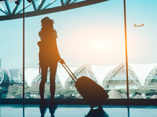 Woman looking out airport window