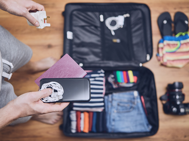 Man packing suitcase for holiday