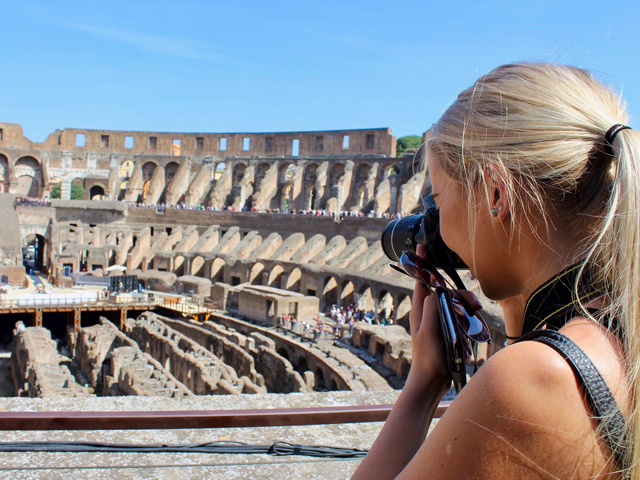 Girl taking photo in colosseum