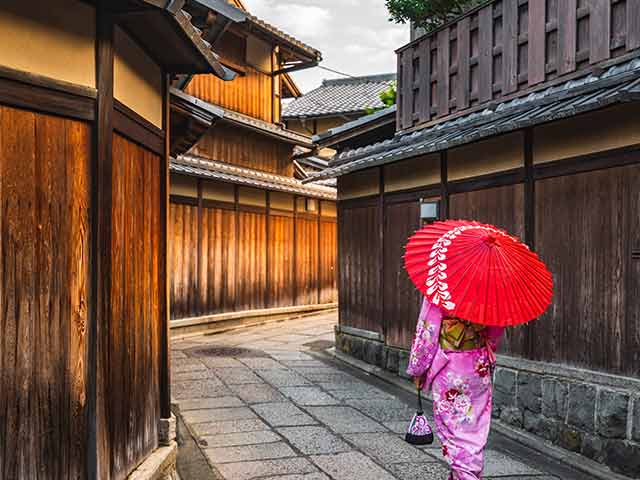 Japanese lady walking with red umbrella
