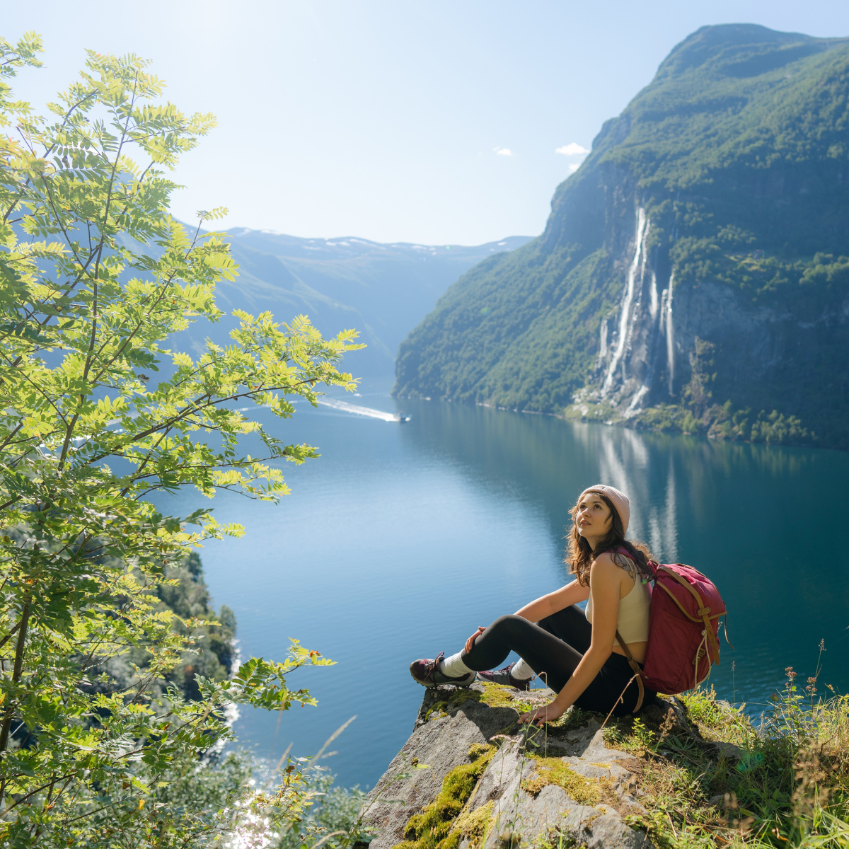 A female traveller sitting on a rock in New Zealand