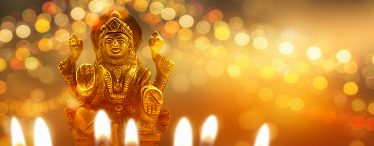 Hindu Goddess Lakshmi with traditional lamps and candles Hindu Goddess Lakshmi with traditional lamps and candles