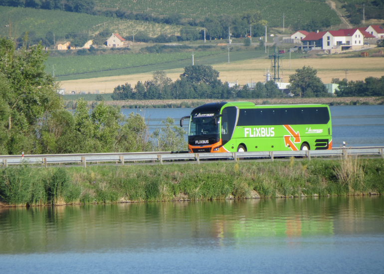 Bus travel around Europe Green Flixbus driving through Czech Republic