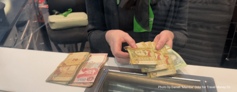 Travel Money Oz expert consultant exchanging foreign currency at a Travel Money Oz store.