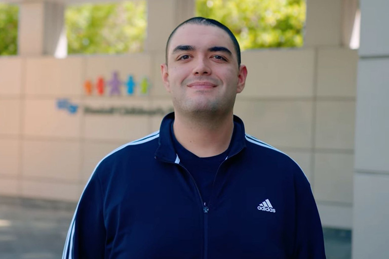 Andrew smiling outside UCSF Benioff Children's Hospital