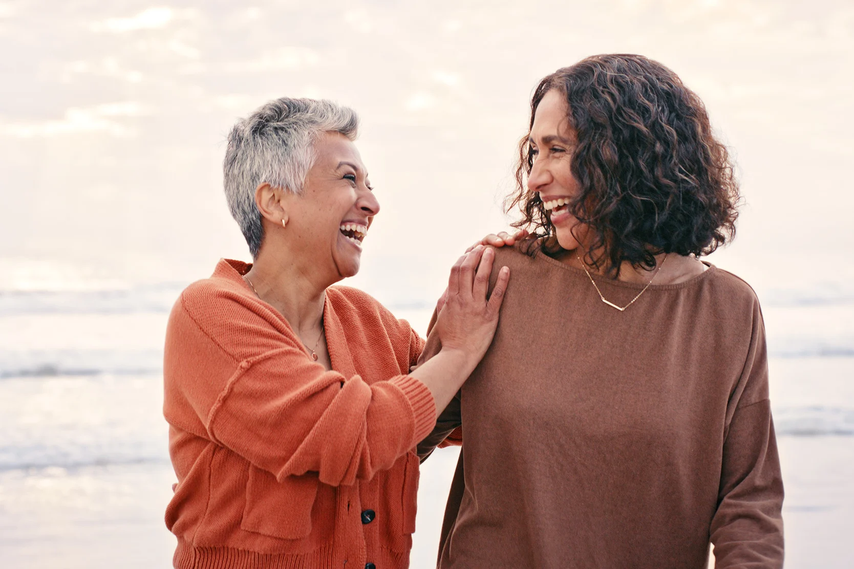An old and a young woman gently smiling at each other