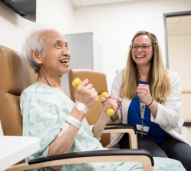 Dr. Stephanie E. Rogers, Assistant Professor of Medicine in the UCSF Division of Geriatrics, does an exercise class with her patient George Wu.