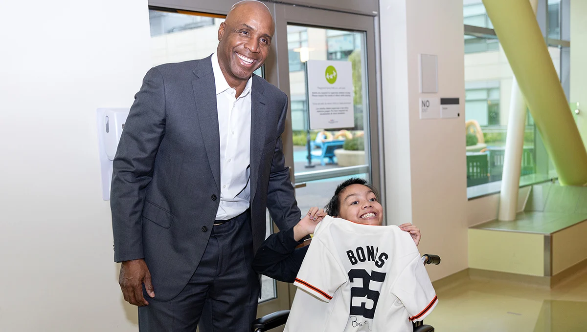 Man with a child holding a t-shirt