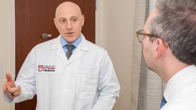 Surgeon Ryan Merkow, MD, in clinic