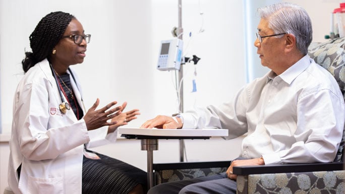 Olatoyosi Odenike, MD, and patient in infusion area