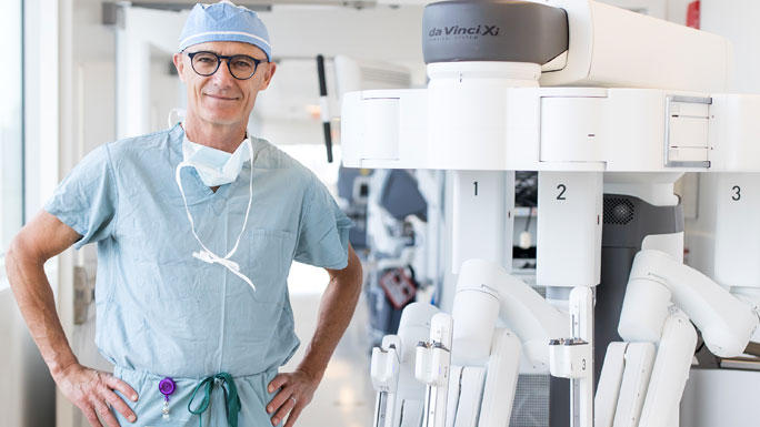 Urologist Arieh Shalhav, MD, with a da Vinci surgical robot