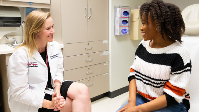 Breast surgeon Sarah Shubeck, MD, meets with a patient in clinic