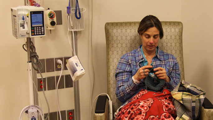Outpatient stem cell transplant recipient Rebecca Zoltoski, knitting while receiving treatment