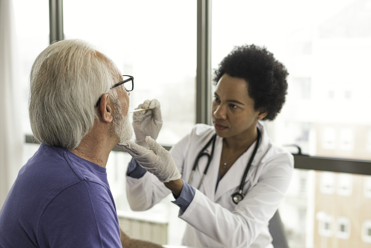 female dermatologist examining man's arm