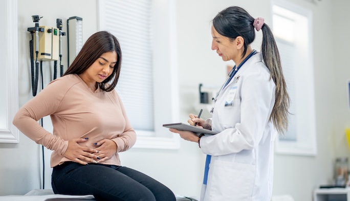 female patient with abdominal pain seeing physician