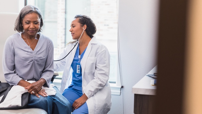 physician listening to patients lungs