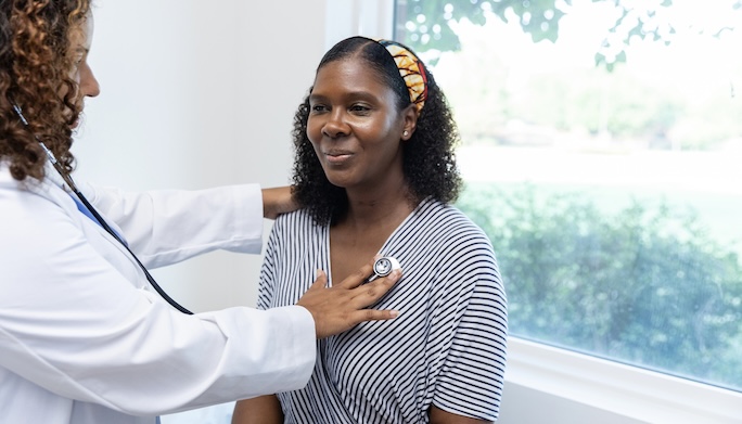 physician listening to patients lungs