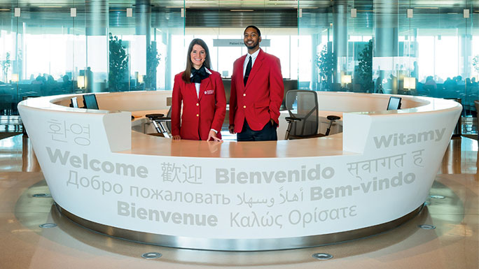 Greeters at Sky Lobby welcome desk in the Center for Care and Discovery