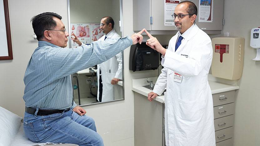 Dr. Prabhakaran and patient practicing exercises