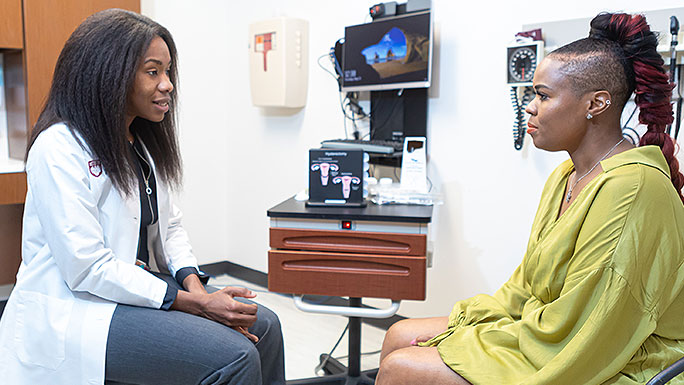 Gynecologic surgeon Sandra Laveaux, MD, MPH, talking with a patient