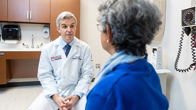 Urogynecologist Juraj Letko, MD, consults with a patient seeking treatment for a pelvic floor condition