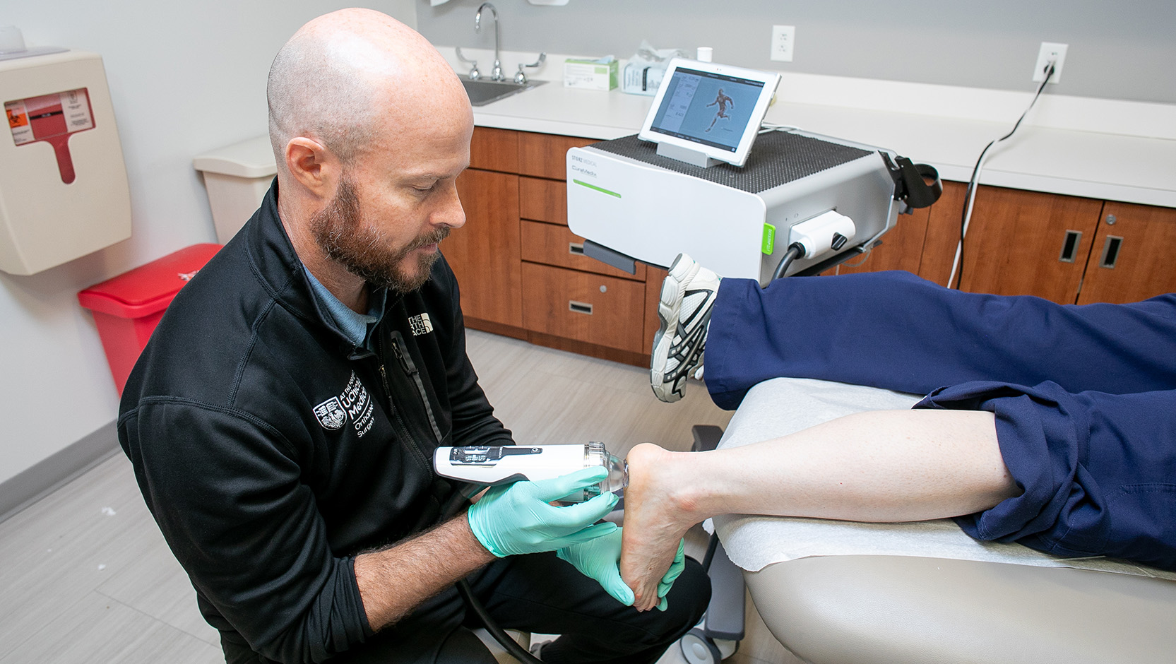 Dr. Ross using Shockwave therapy