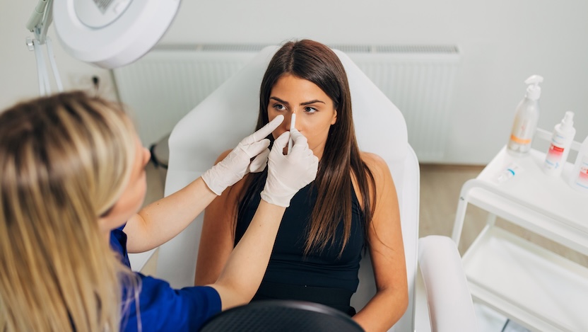 physician drawing on patients nose for rhinoplasty