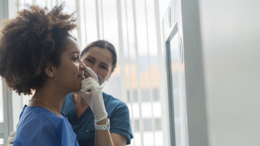 physician looking at patients face