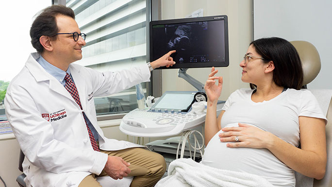 Ryan Longman, MD, reviews ultrasound images with a patient