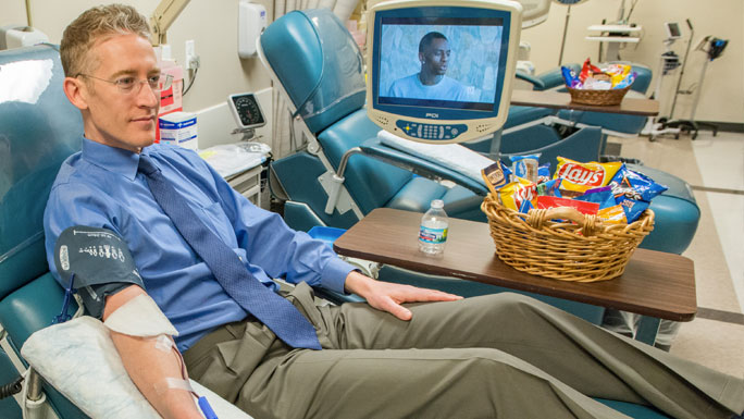 Geoffrey D. Wool, MD, PhD, donating blood in the blood donation center