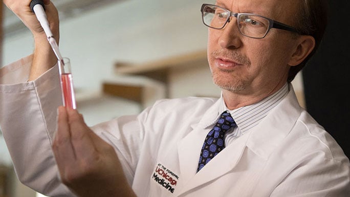 Thomas Gajewski, MD, PhD, with pipette in lab