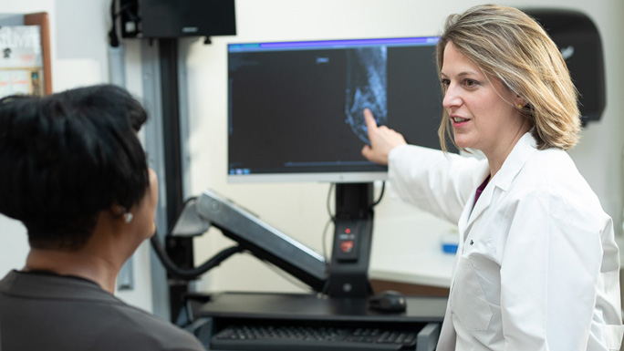 Medical oncologist Olwen Hahn, MD, with patient and CT scan