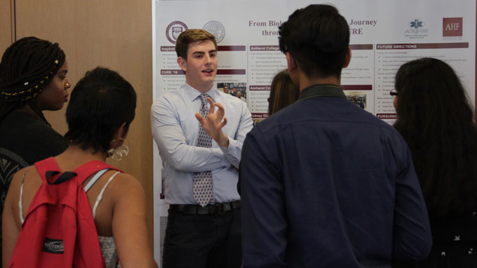 male student presenting research to fellow students