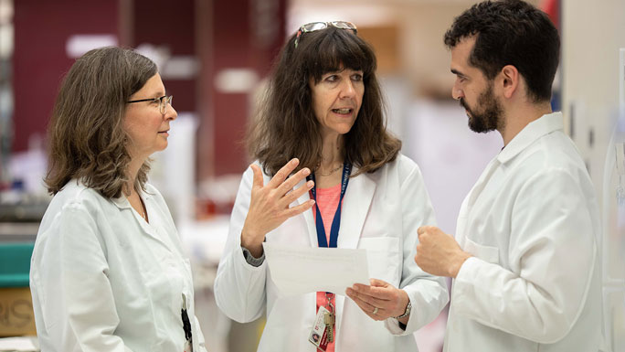 Two female and one male cancer researchers