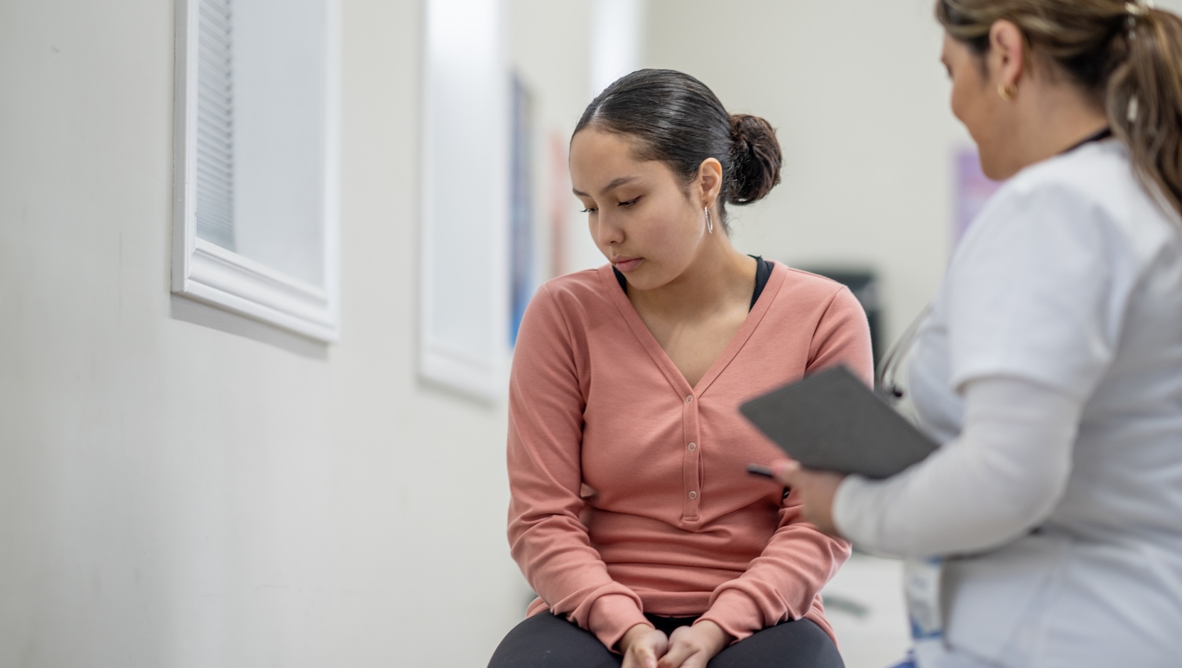 teen female patient talking with female doctor