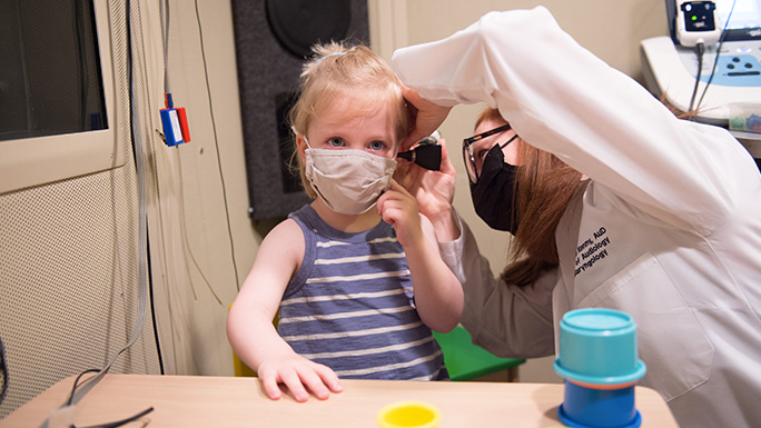 Image of Dr. Jackie Hudson working with a pediatric audiology patient
