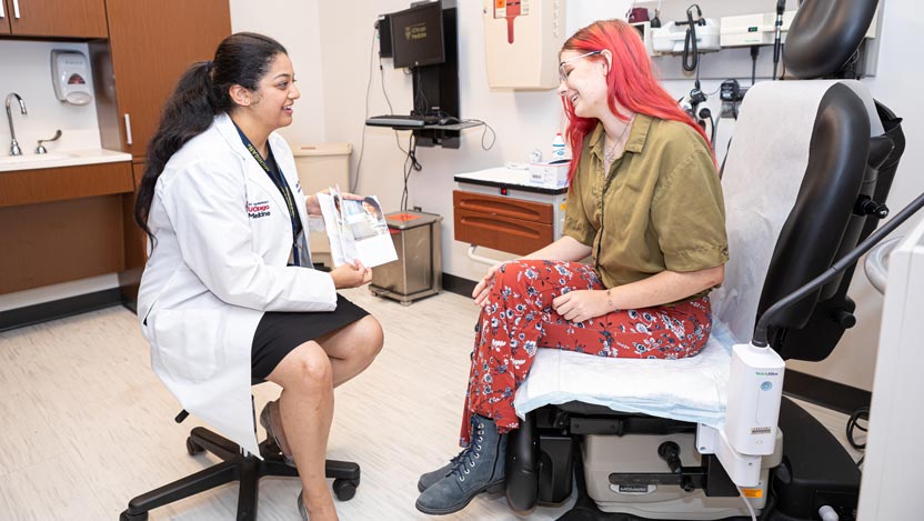 Shashwati Pradhan,MD with a female patient in a clinic room 