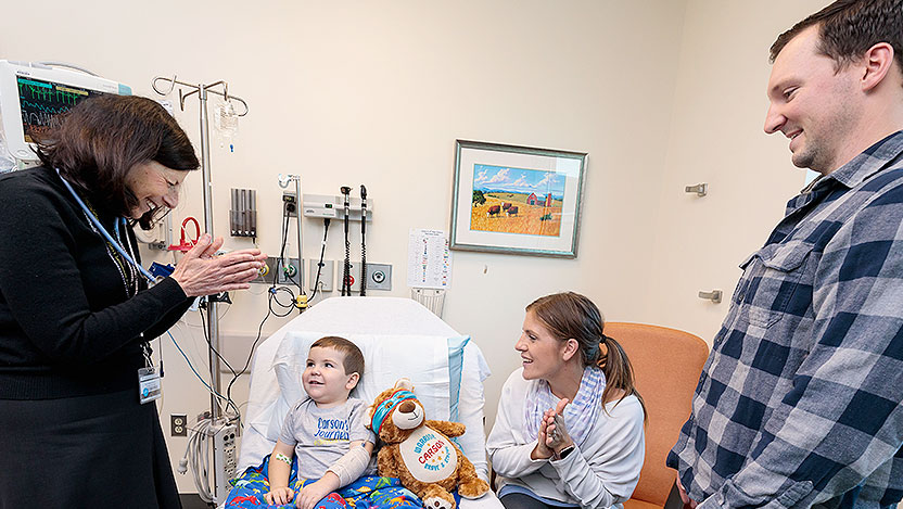 Neuroblastoma specialist Susan Cohn, MD, speaks with a young patient and his parents