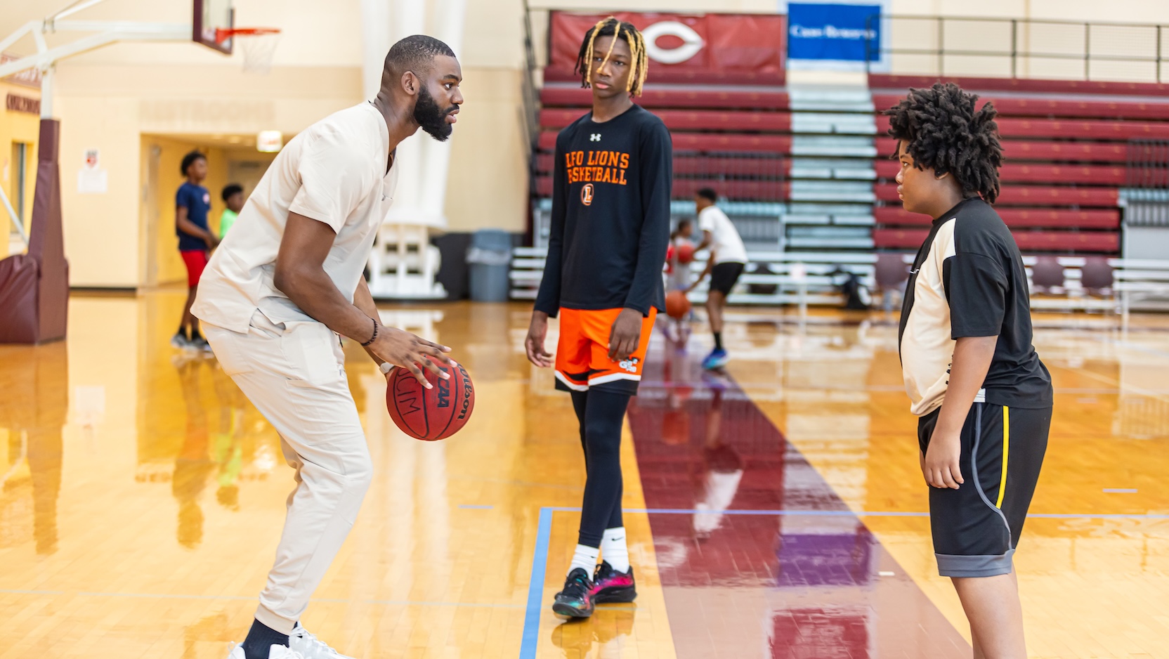 Medical student Jameel Alausa playing basketball for a Sneakers to Scrubs event