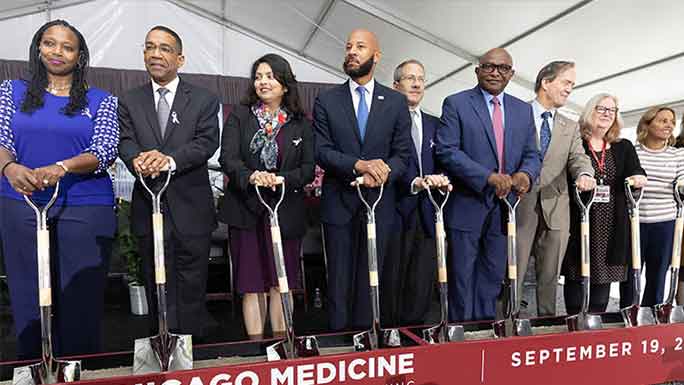 Participants pose with shovels at UChicago Medicine cancer pavilion groundbreaking event