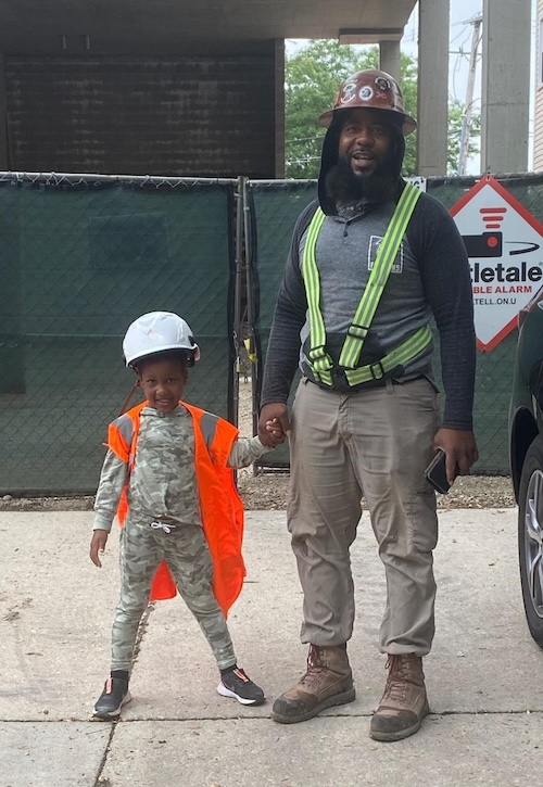 Construction worker and daughter in hard hats