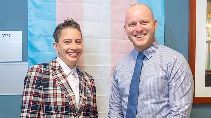 Iris Romero, MD, and Andrew Fisher, MD, with a Transgender Pride Flag